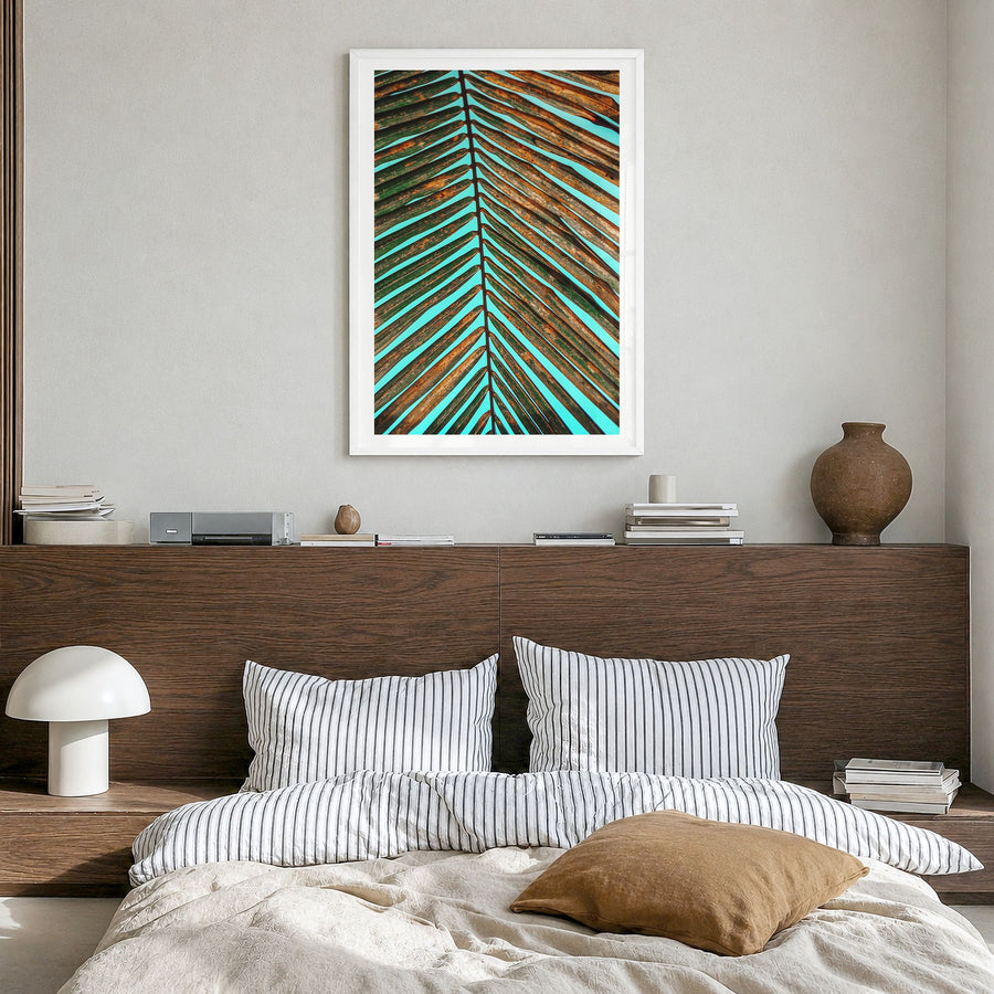Palm Tree Leaf Photo Poster in a white wood frame, hanging in a bedroom, white border