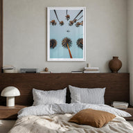 Palm Trees, Sky and Aircraft colorful photo poster – vertical wall art in white wood frame with white border, hanging on wall