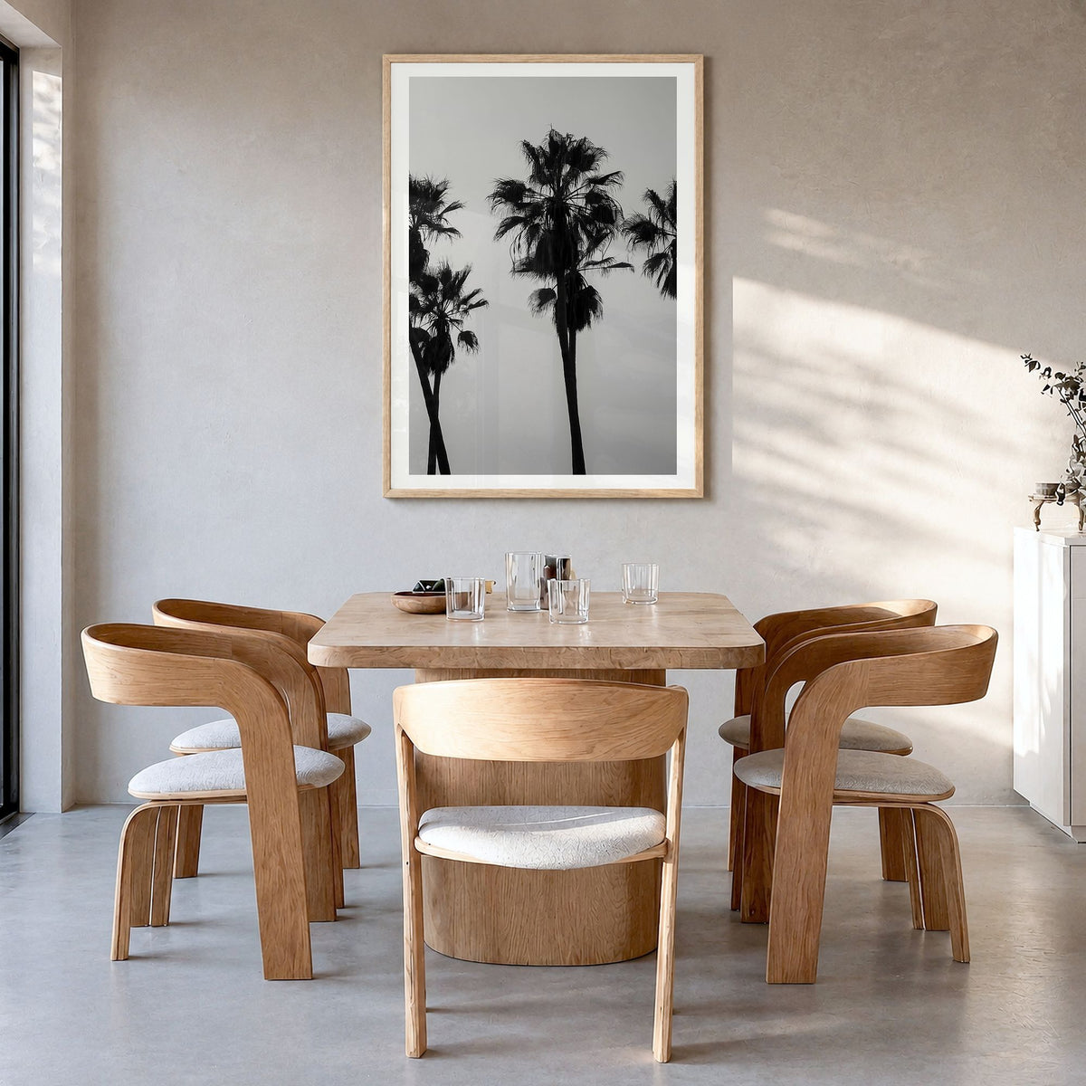 Palms Photo Poster in a natural wood frame, hanging in a dining room, white border