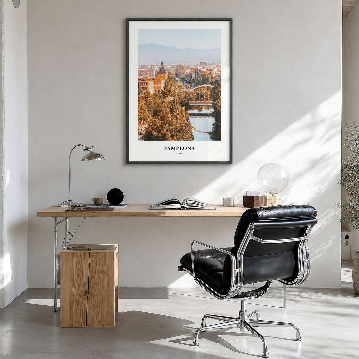 Pamplona Classic Poster in a black wood frame, hanging in a bright home office