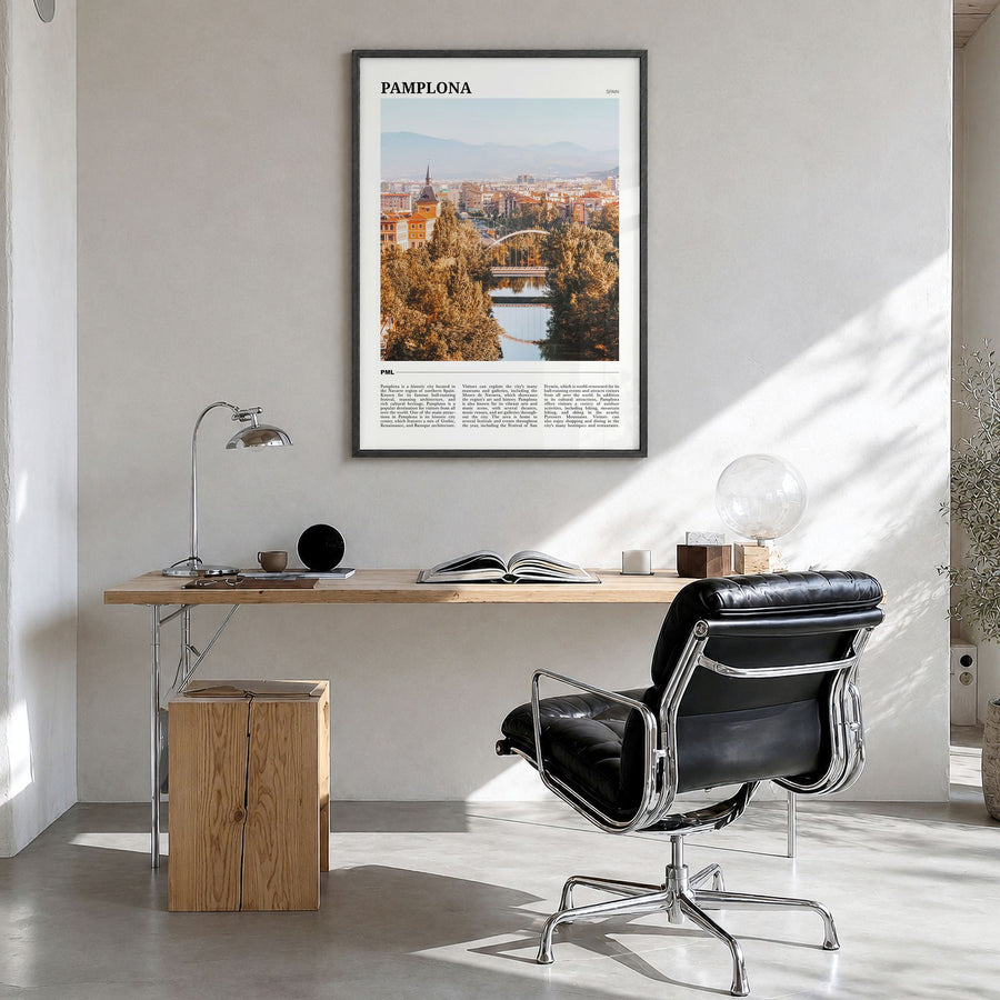 Pamplona Travel Poster in a black wood frame, hanging in a bright home office