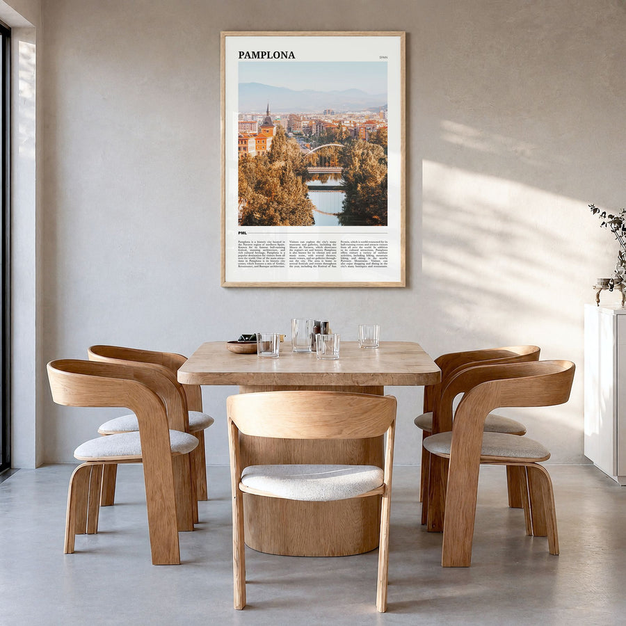 Pamplona Travel Poster in a natural wood frame, hanging in a dining room