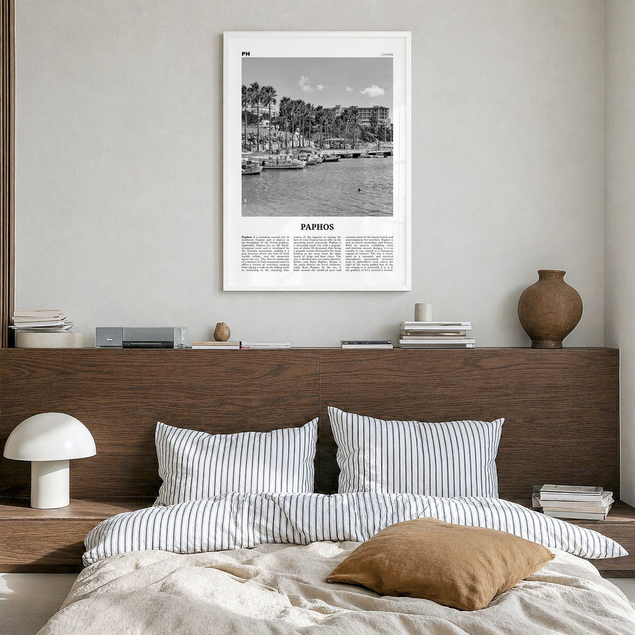 Paphos Newspaper Poster in a white wood frame, hanging in a bedroom