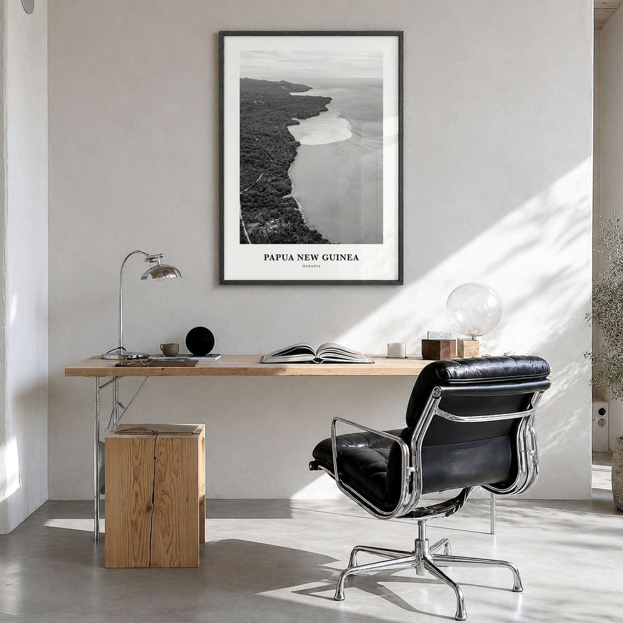 Papua New Guinea Classic Poster in a black wood frame, hanging in a bright home office