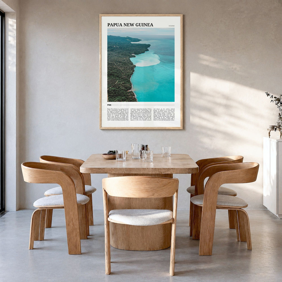 Papua New Guinea Travel Poster in a natural wood frame, hanging in a dining room