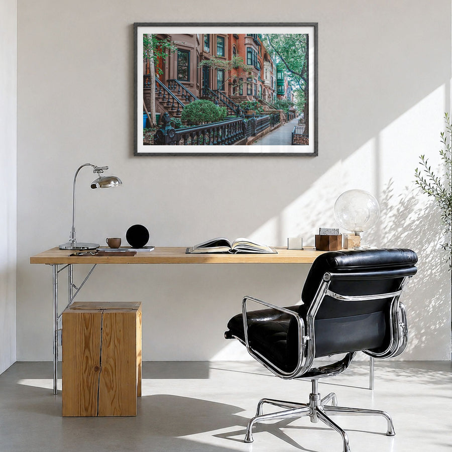 Park Slope Photo Poster in a black wood frame, hanging in a bright home office, white border