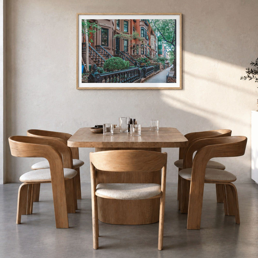 Park Slope Photo Poster in a natural wood frame, hanging in a dining room, white border