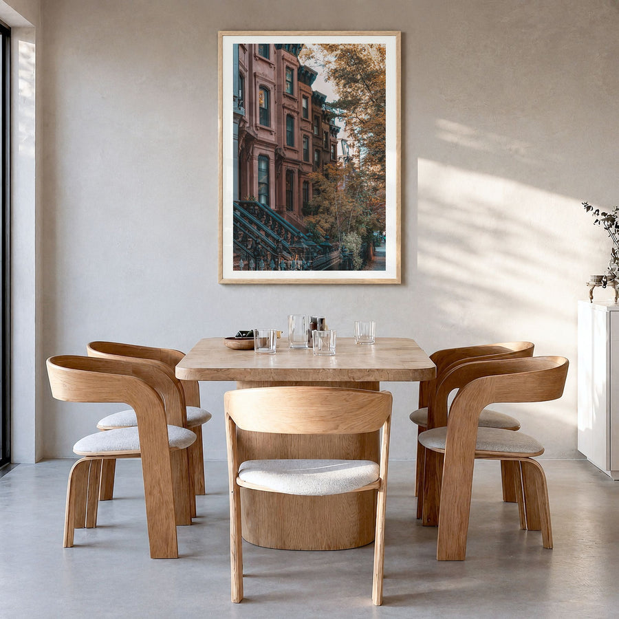 Park Slope Photo Poster in a natural wood frame, hanging in a dining room, white border