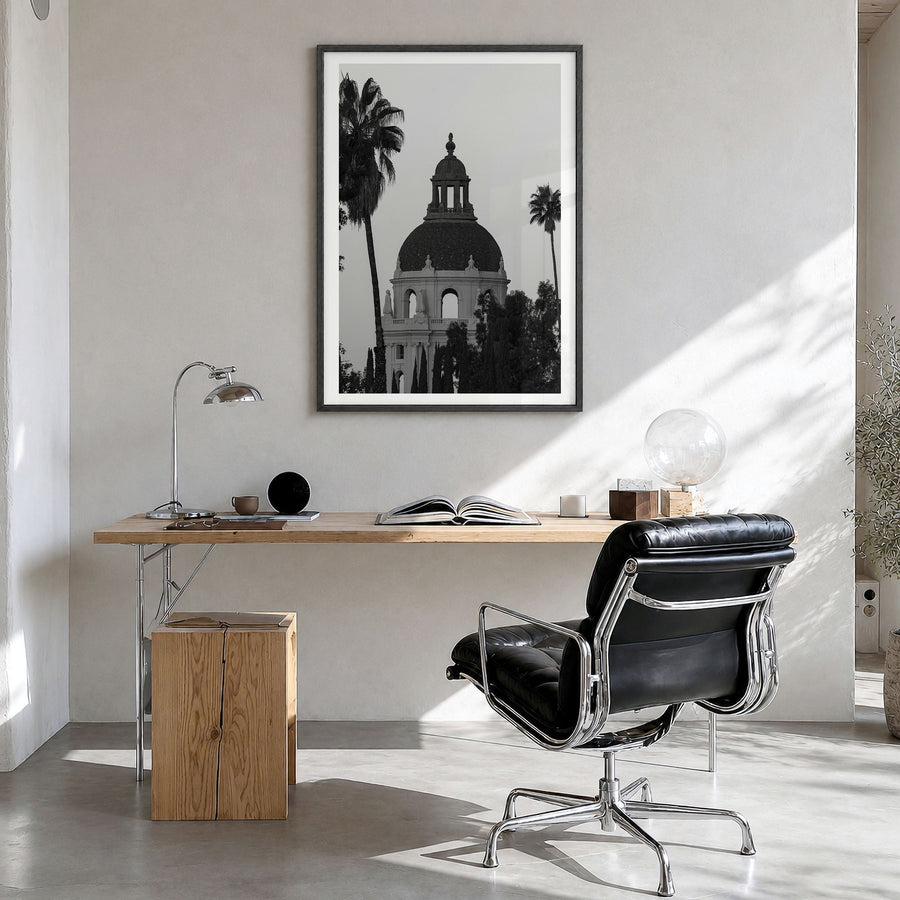 Pasadena Photo Poster in a black wood frame, hanging in a bright home office, white border