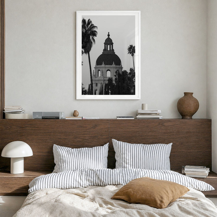 Pasadena Photo Poster in a white wood frame, hanging in a bedroom, white border