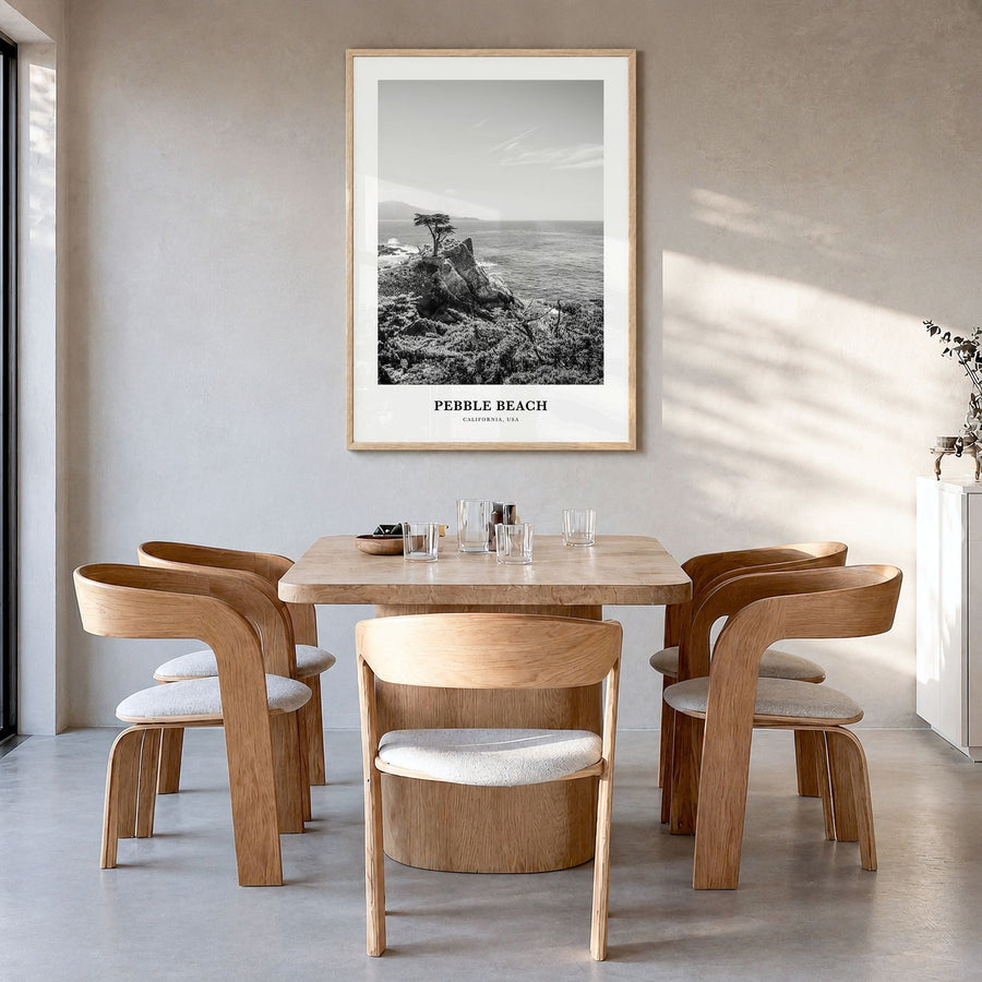 Pebble Beach Classic Poster in a natural wood frame, hanging in a dining room
