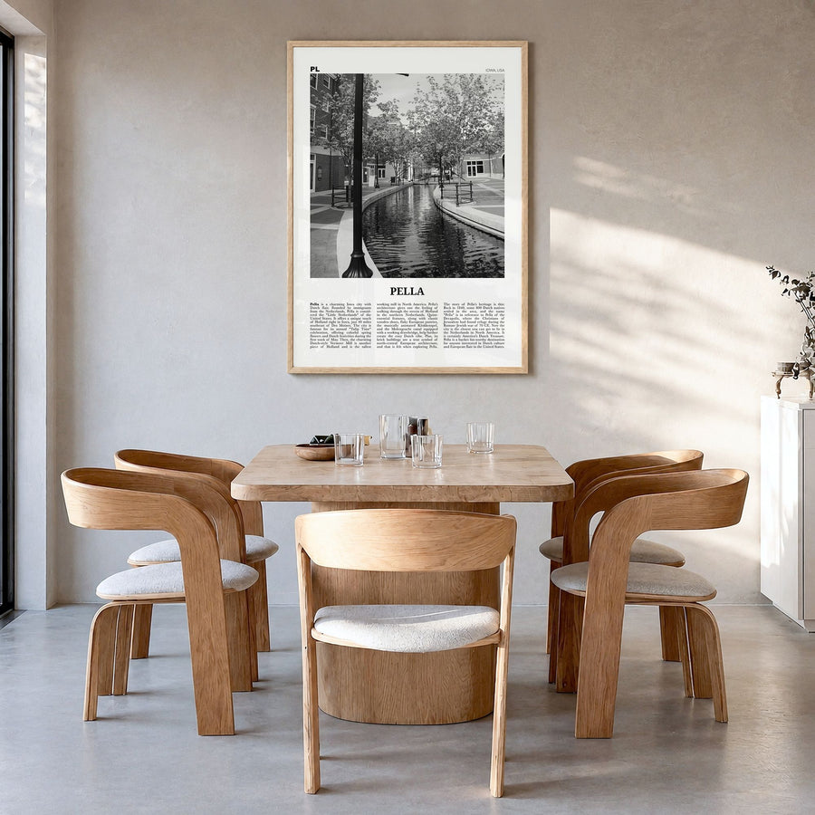 Pella, Iowa Newspaper Poster in a natural wood frame, hanging in a dining room
