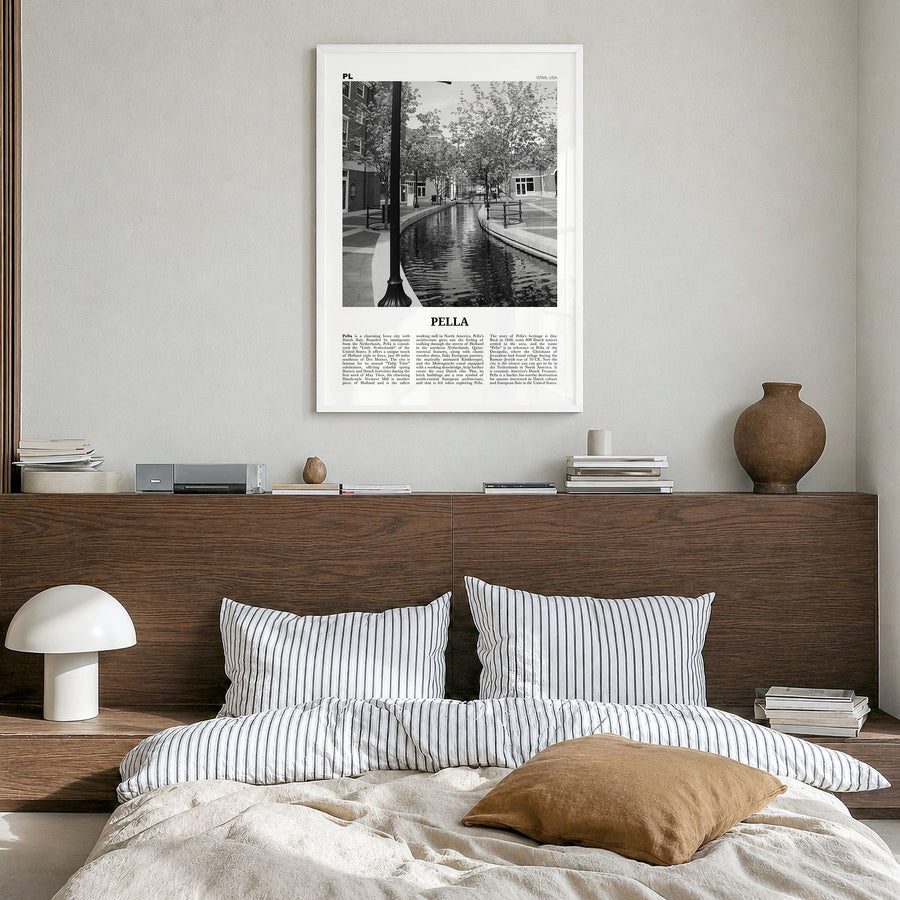 Pella, Iowa Newspaper Poster in a white wood frame, hanging in a bedroom