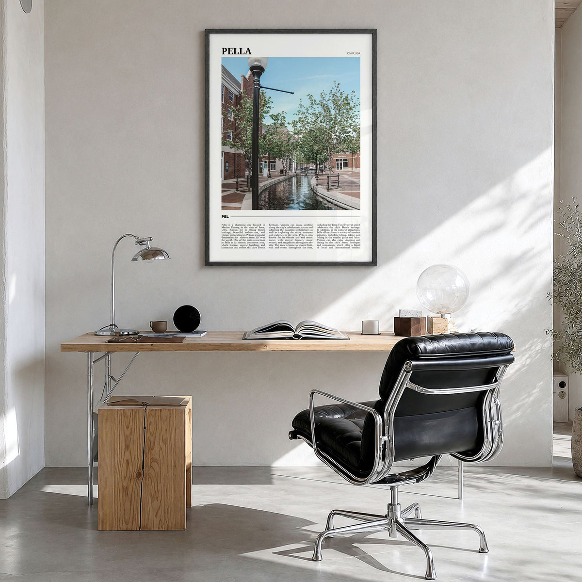Pella, Iowa Travel Poster in a black wood frame, hanging in a bright home office