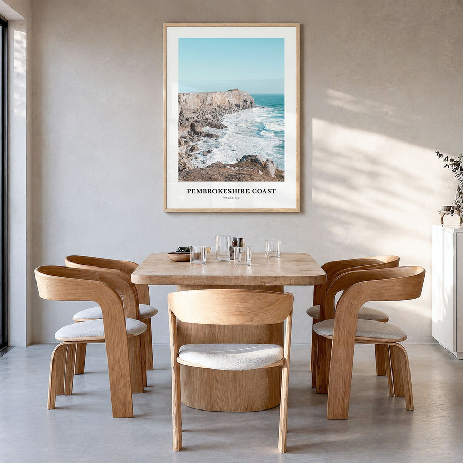 Pembrokeshire Coast Classic Poster in a natural wood frame, hanging in a dining room