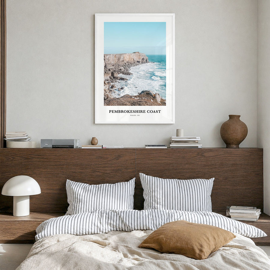 Pembrokeshire Coast Classic Poster in a white wood frame, hanging in a bedroom