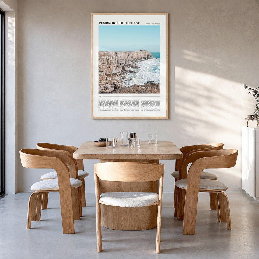 Pembrokeshire Coast Travel Poster in a natural wood frame, hanging in a dining room