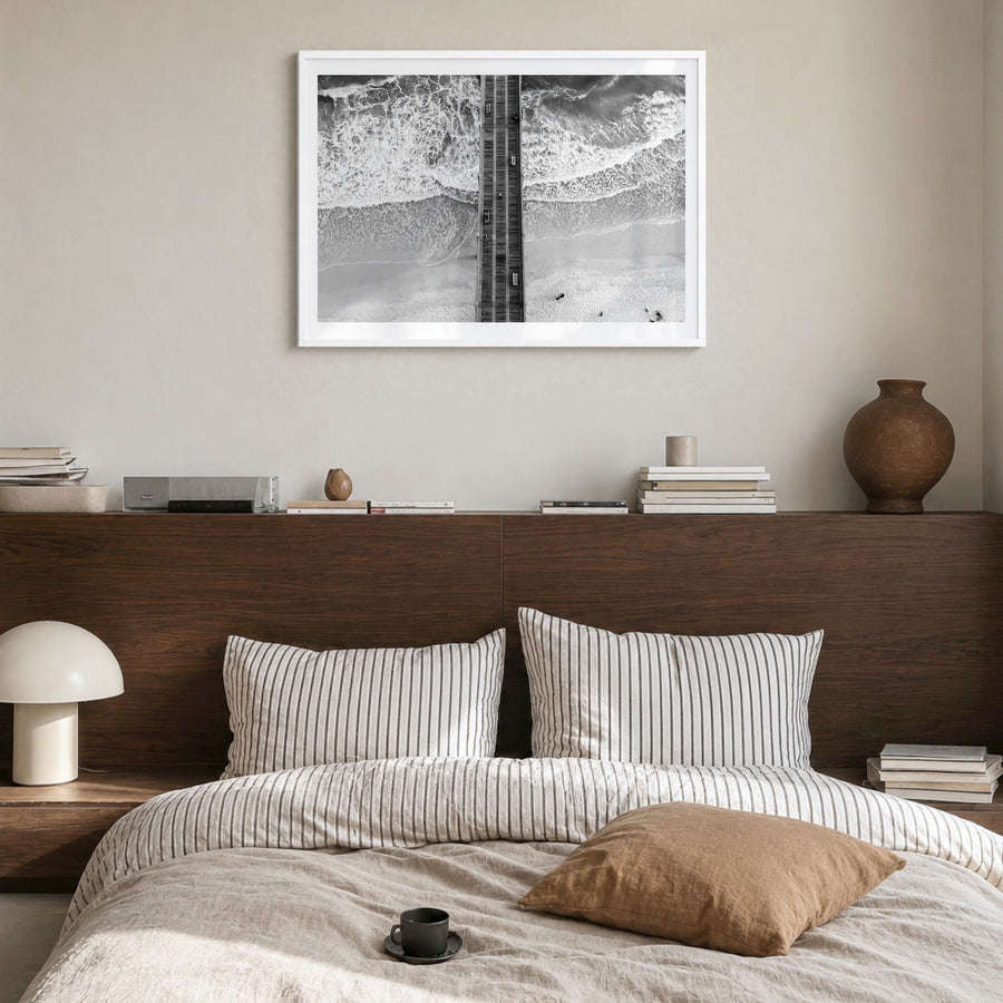 Pensacola Photo Poster in a white wood frame, hanging in a bedroom, white border