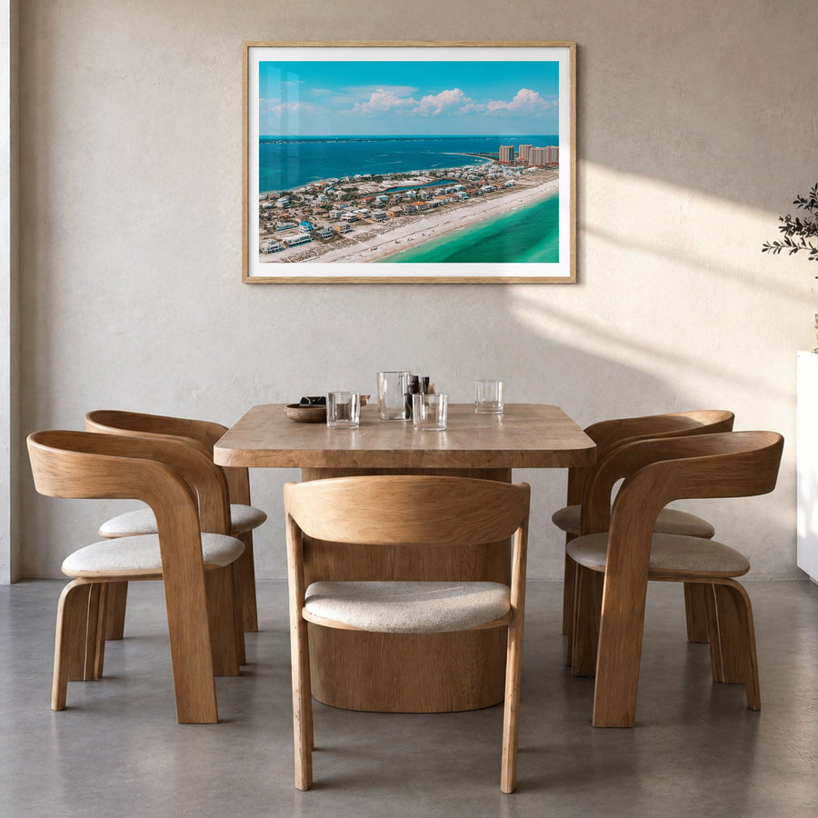 Pensacola Photo Poster in a natural wood frame, hanging in a dining room, white border