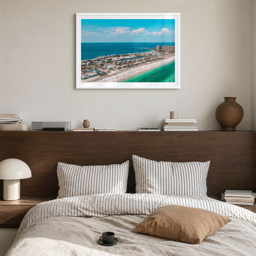 Pensacola Photo Poster in a white wood frame, hanging in a bedroom, white border