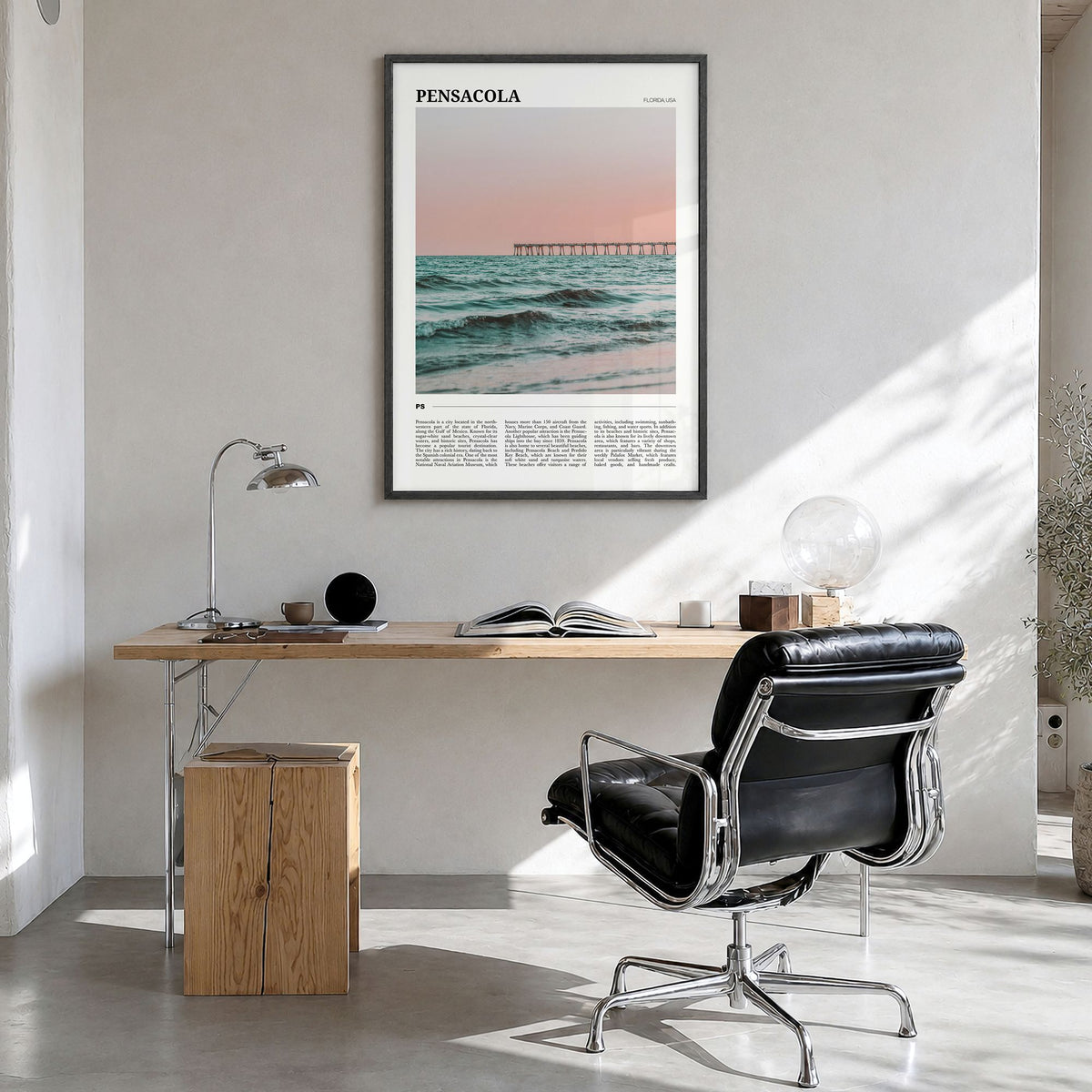 Pensacola Travel Poster in a black wood frame, hanging in a bright home office