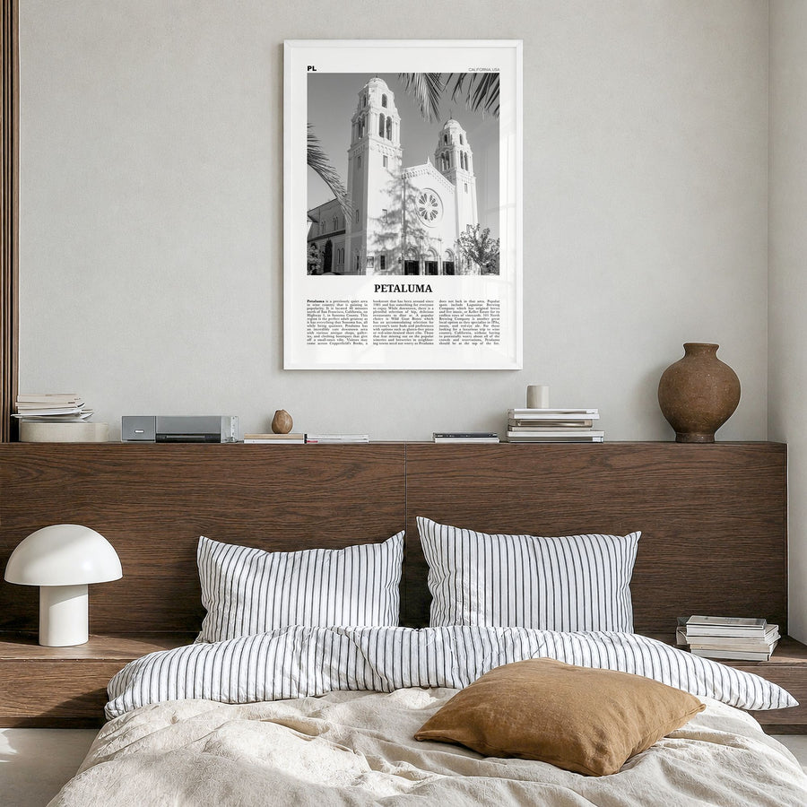 Petaluma Newspaper Poster in a white wood frame, hanging in a bedroom