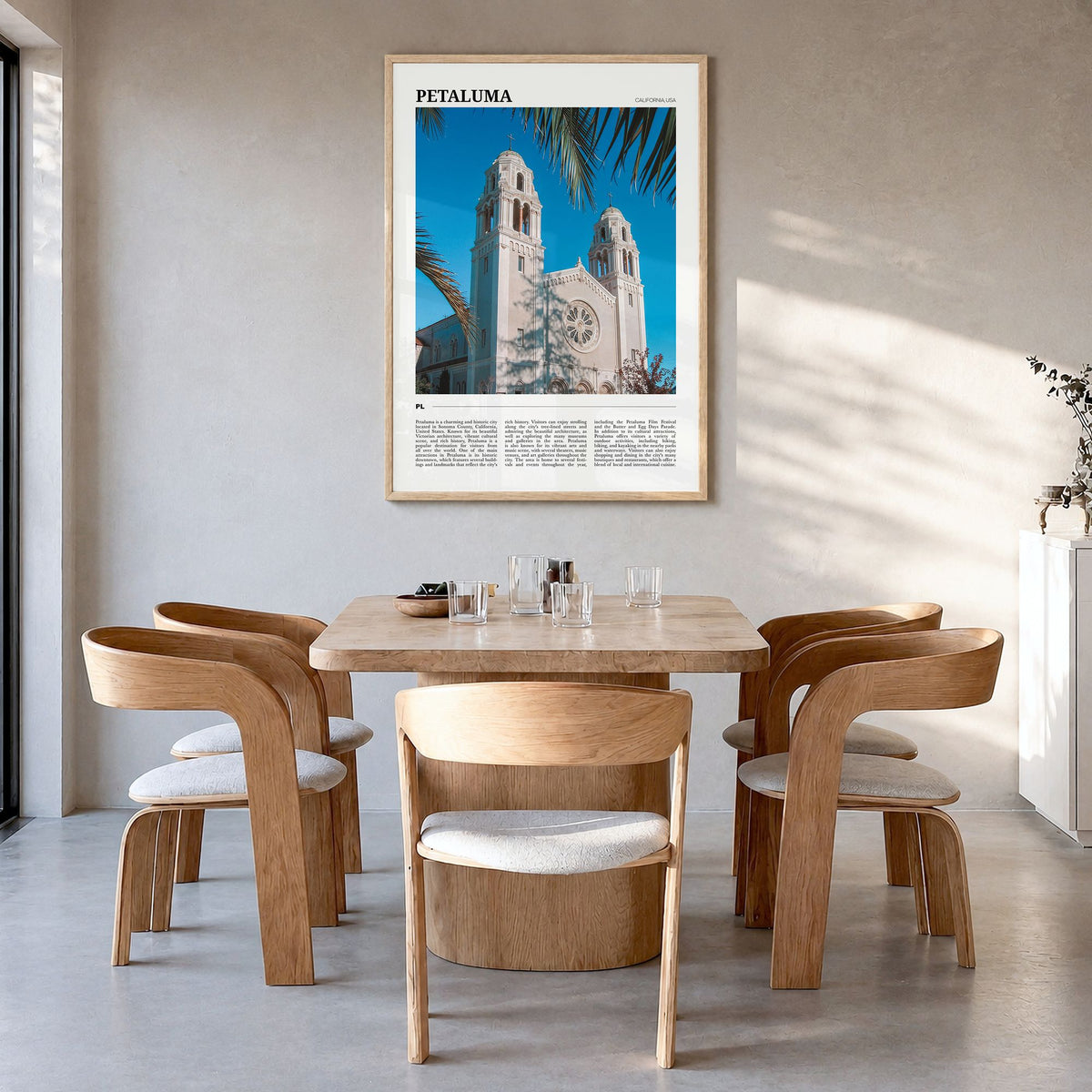 Petaluma Travel Poster in a natural wood frame, hanging in a dining room