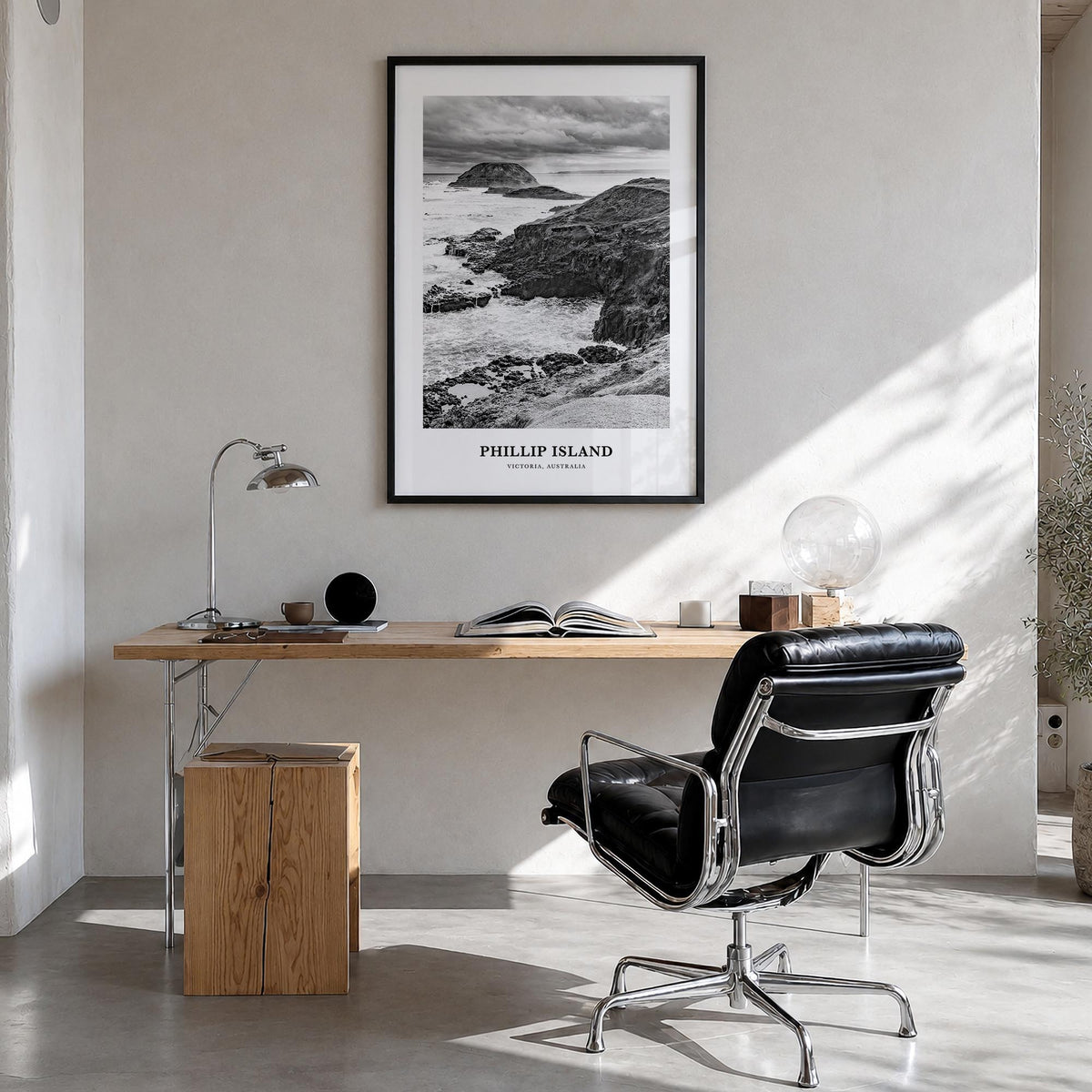 Phillip Island black & white classic poster of Australia – vertical wall art in black wood frame, hanging on wall