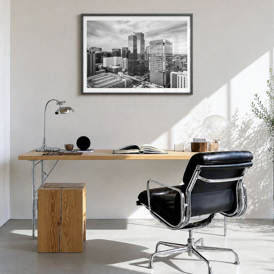 Phoenix Photo Poster in a black wood frame, hanging in a bright home office, white border