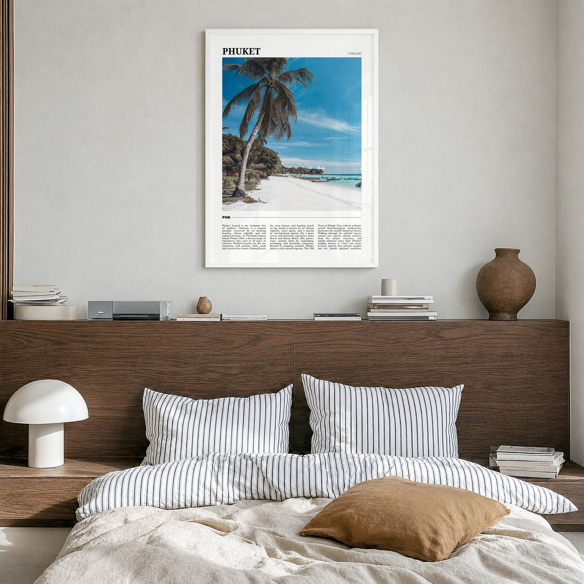 Phuket Travel Poster in a white wood frame, hanging in a bedroom