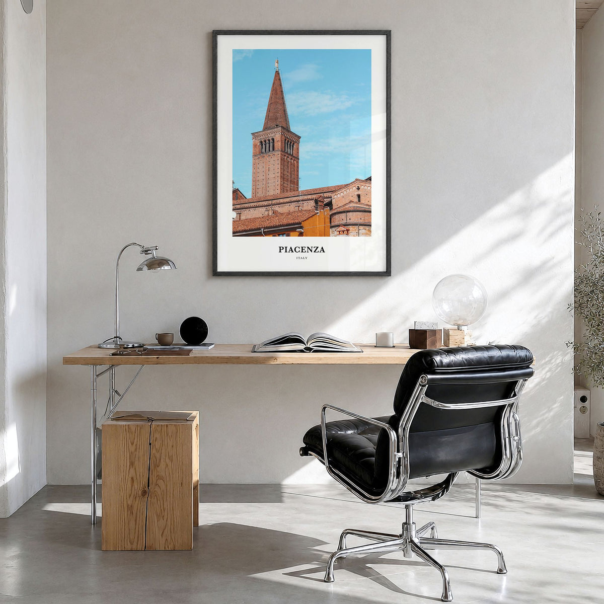 Piacenza Classic Poster in a black wood frame, hanging in a bright home office