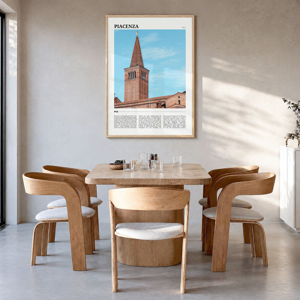 Piacenza Travel Poster in a natural wood frame, hanging in a dining room