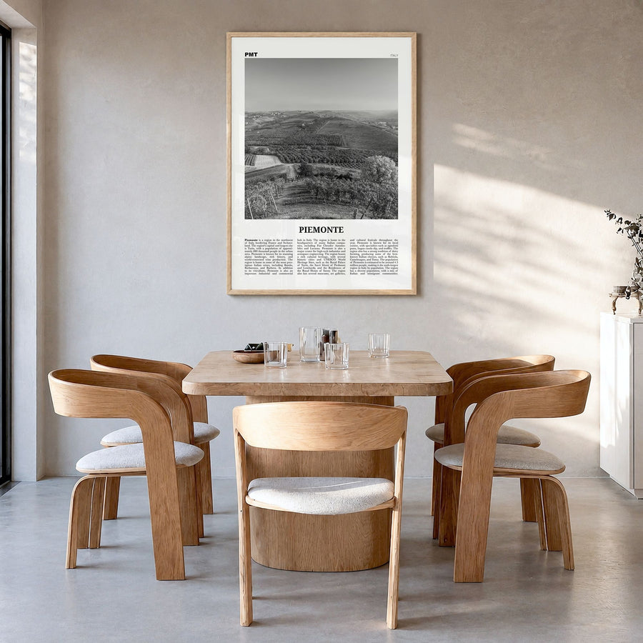 Piemonte Newspaper Poster in a natural wood frame, hanging in a dining room