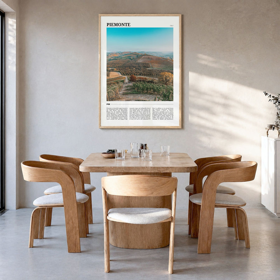 Piemonte Travel Poster in a natural wood frame, hanging in a dining room