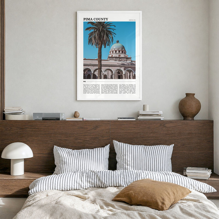 Pima County Travel Poster in a white wood frame, hanging in a bedroom