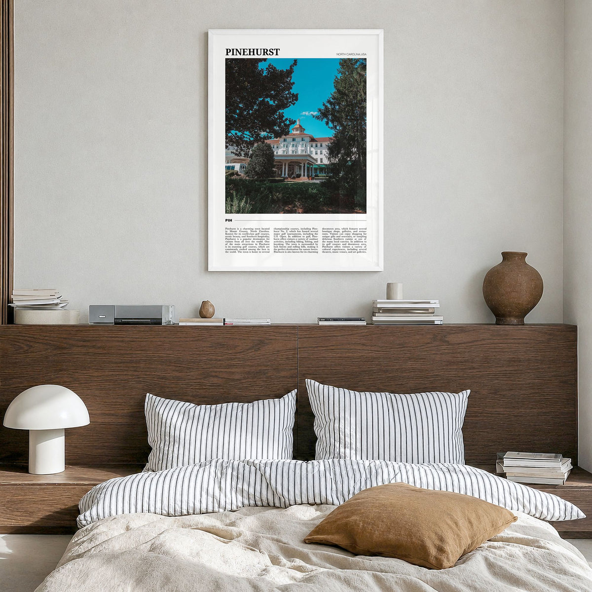 Pinehurst Travel Poster in a white wood frame, hanging in a bedroom