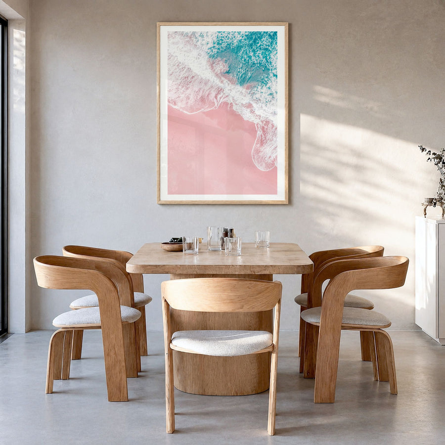 Pink Sandy Beach Photo No 2 Poster in a natural wood frame, hanging in a dining room, white border