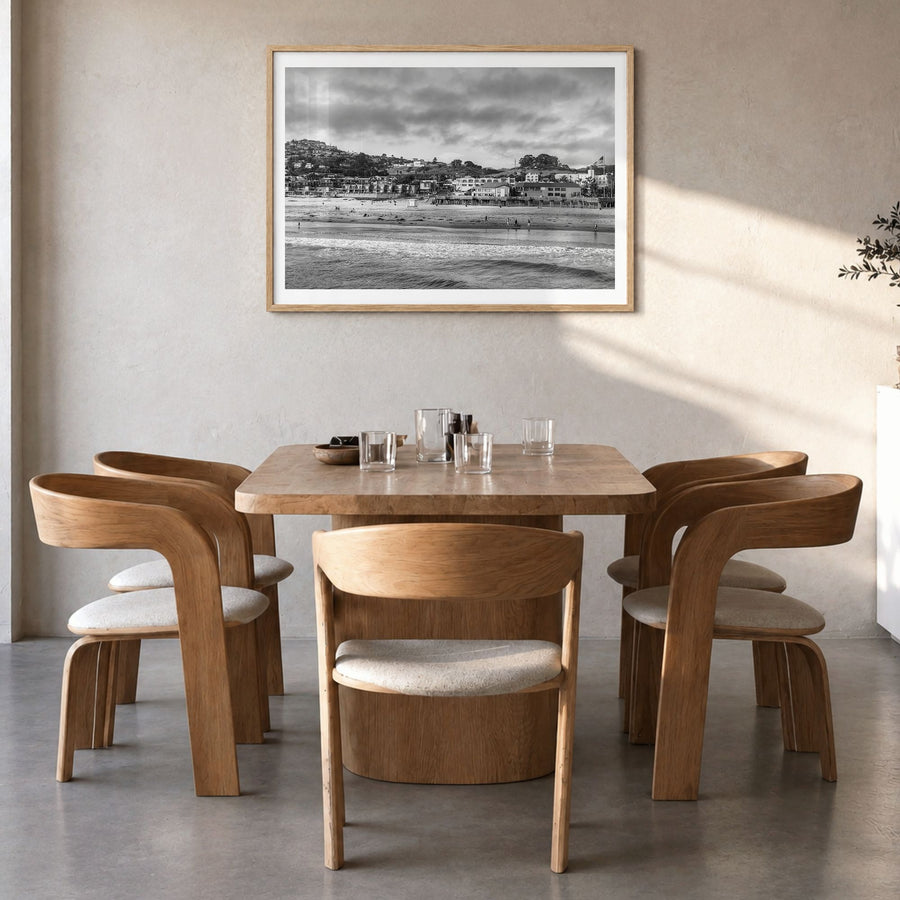 Pismo Beach Photo Poster in a natural wood frame, hanging in a dining room, white border