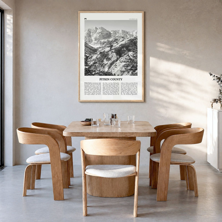 Pitkin County Newspaper Poster in a natural wood frame, hanging in a dining room