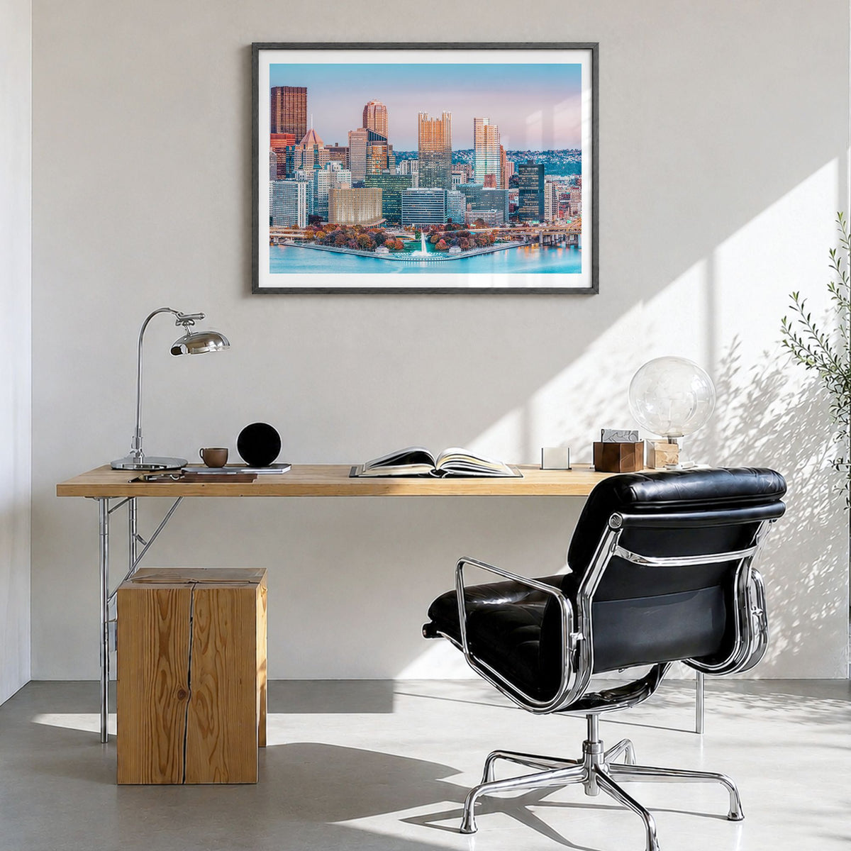 Pittsburgh Photo Poster in a black wood frame, hanging in a bright home office, white border