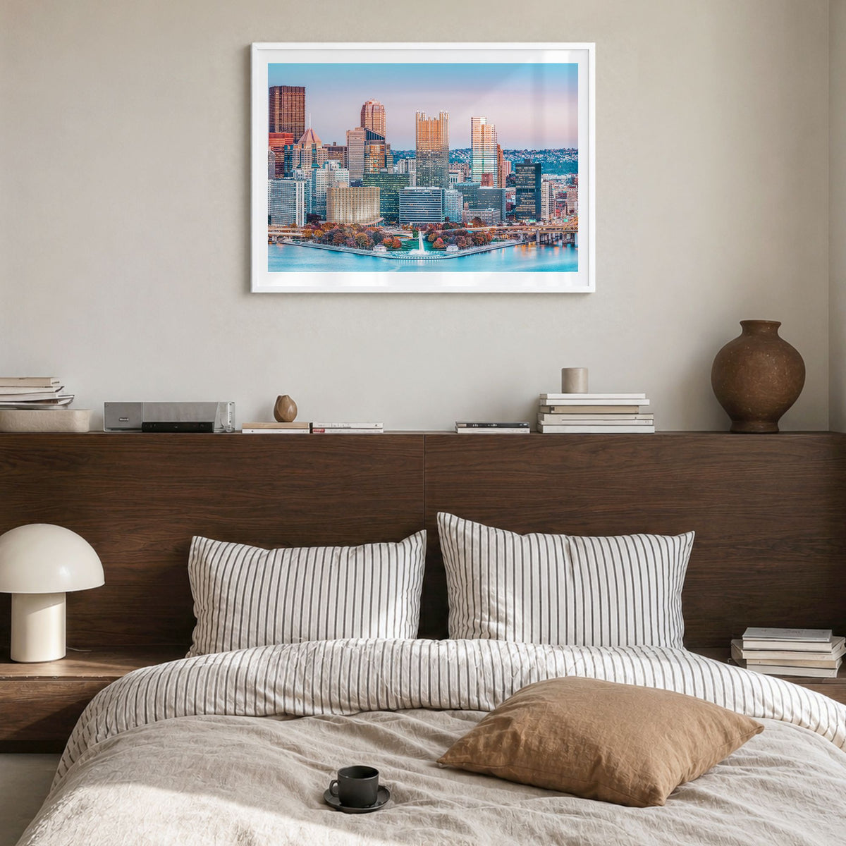 Pittsburgh Photo Poster in a white wood frame, hanging in a bedroom, white border