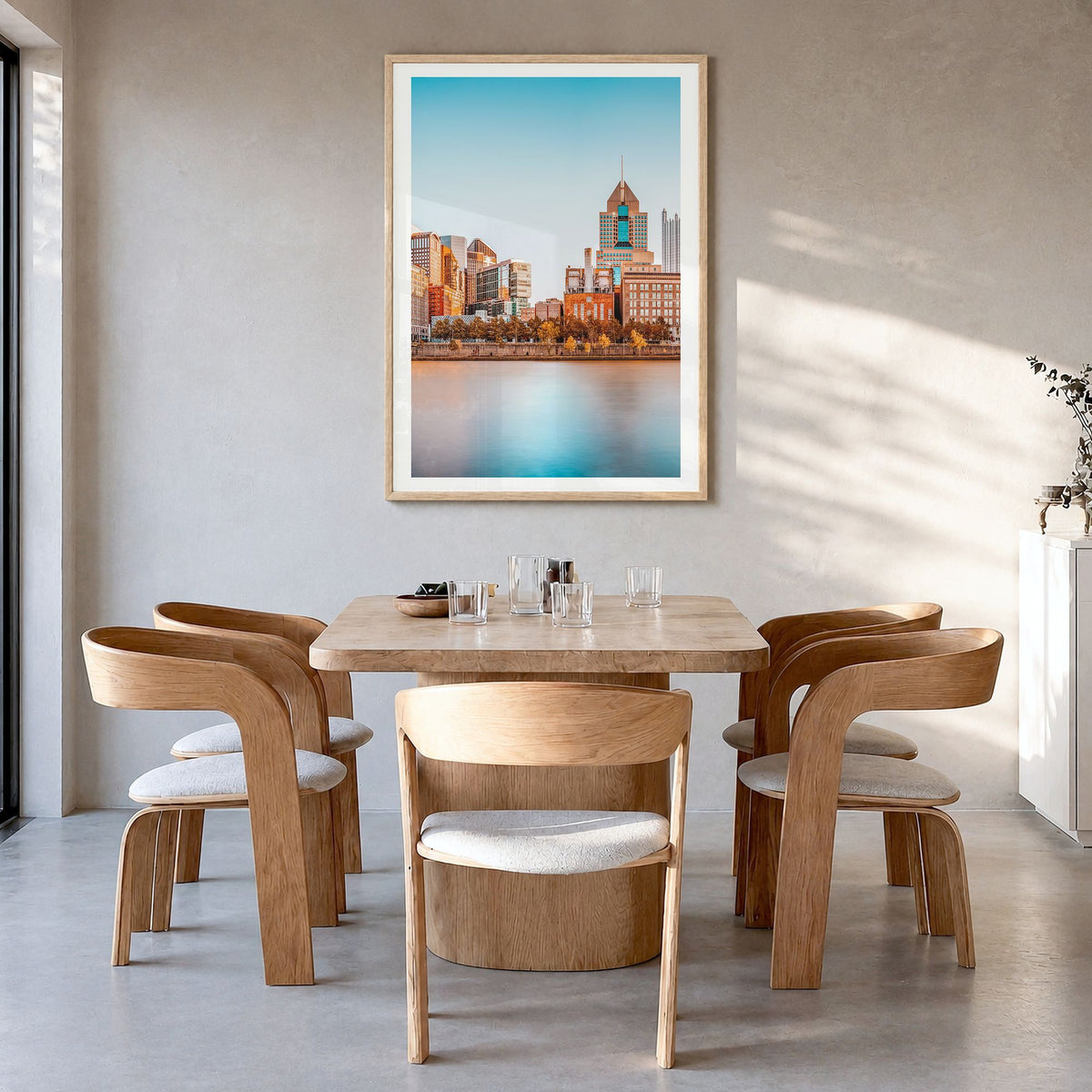Pittsburgh Photo Poster in a natural wood frame, hanging in a dining room, white border