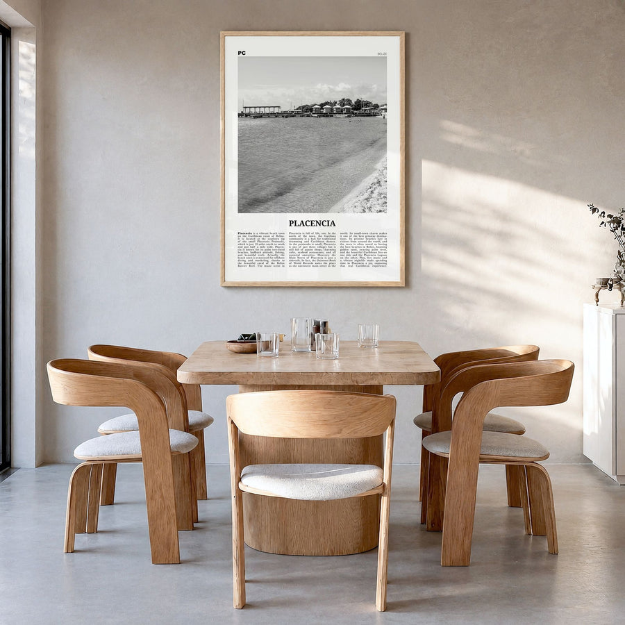 Placencia Newspaper Poster in a natural wood frame, hanging in a dining room