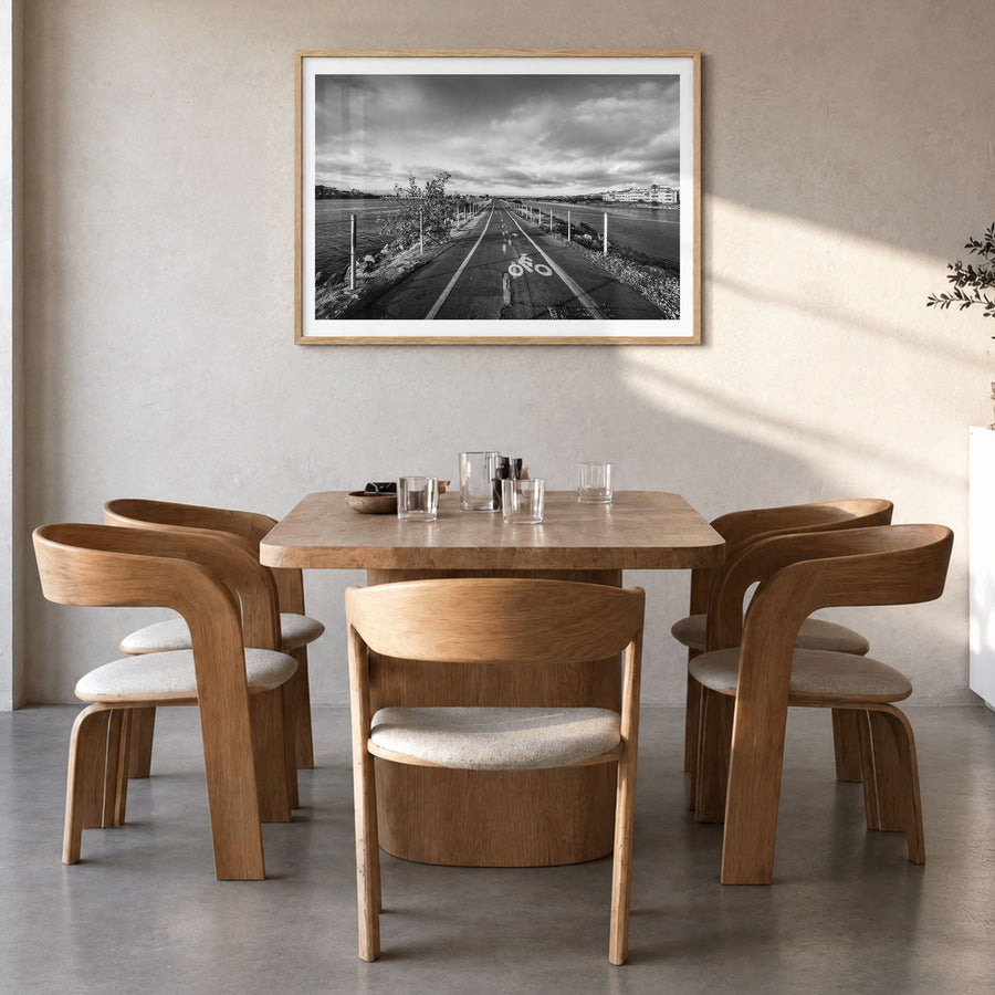Playa del Rey Photo Poster in a natural wood frame, hanging in a dining room, white border