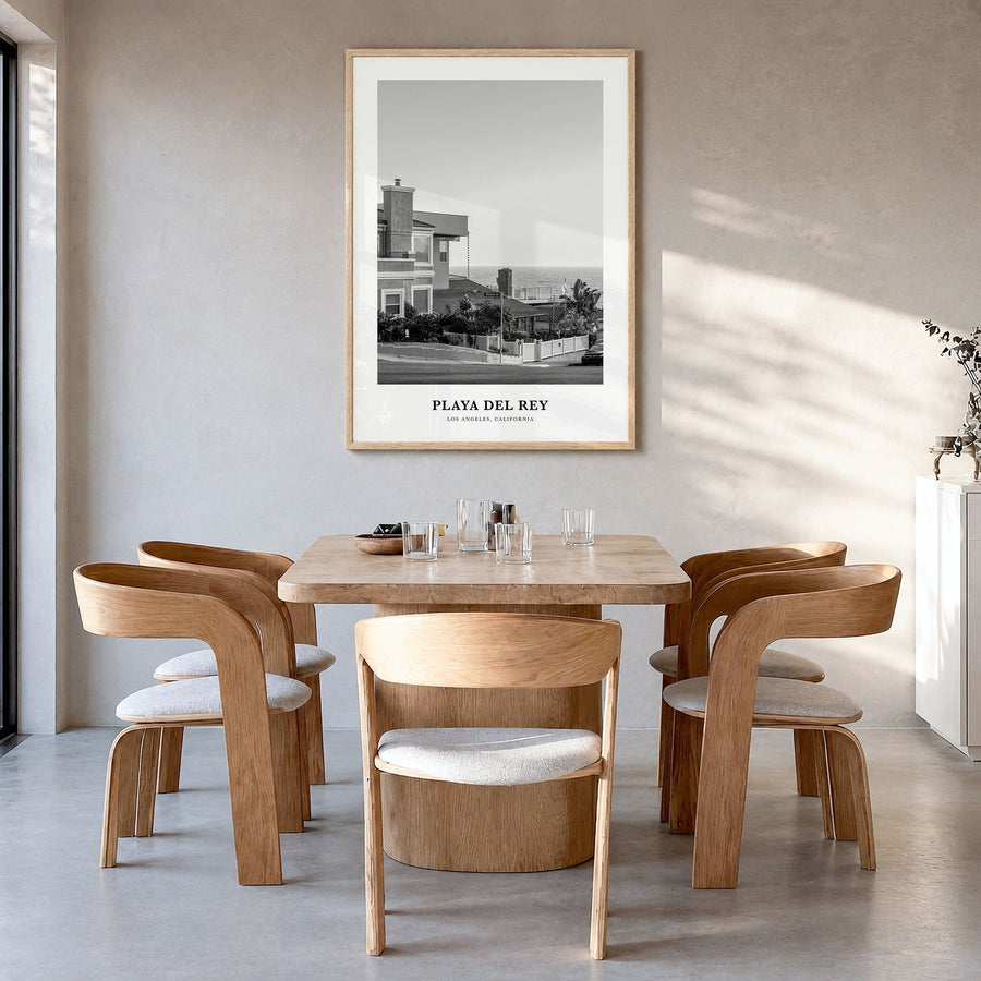 Playa del Rey Classic Poster in a natural wood frame, hanging in a dining room