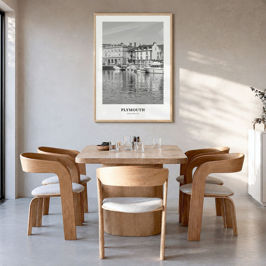 Plymouth Classic Poster in a natural wood frame, hanging in a dining room