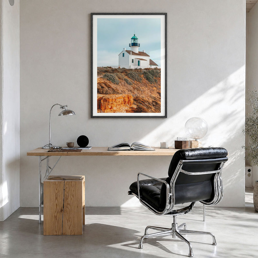 Point Loma Photo Poster in a black wood frame, hanging in a bright home office, white border