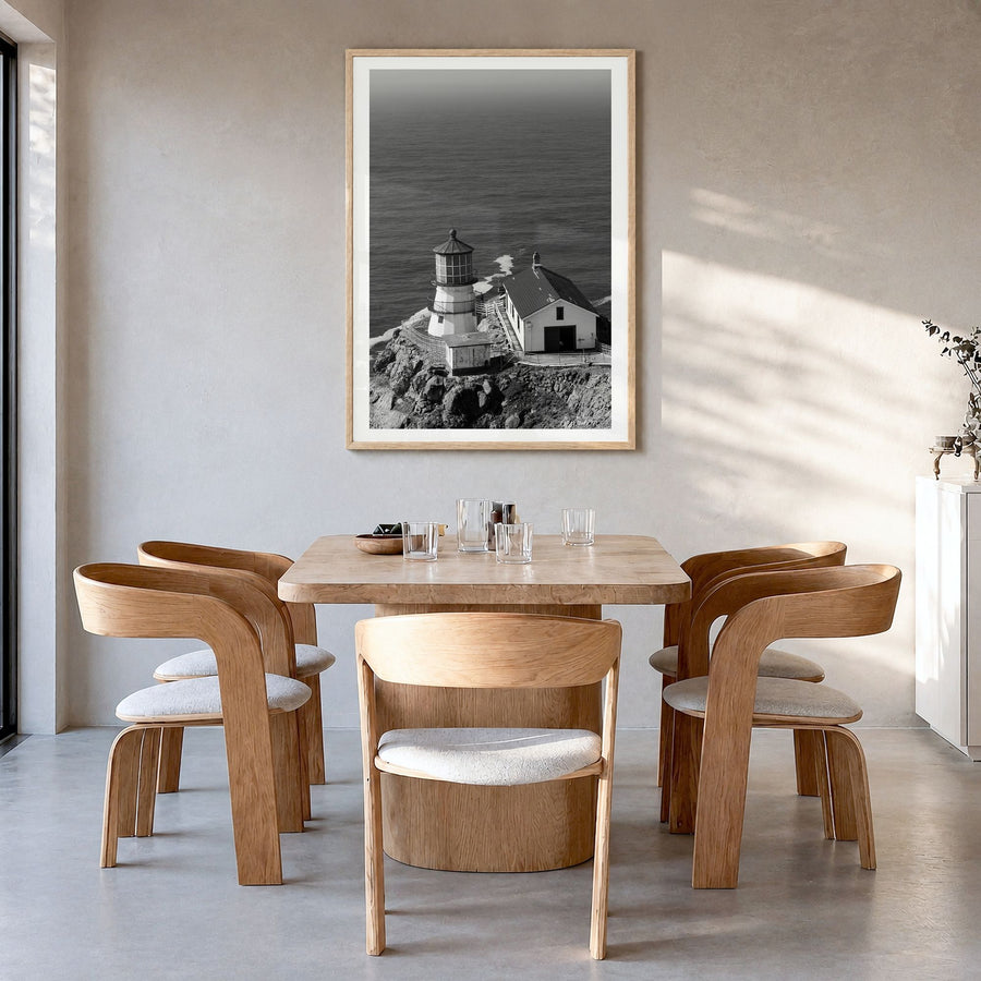 Point Reyes Photo Poster in a natural wood frame, hanging in a dining room, white border