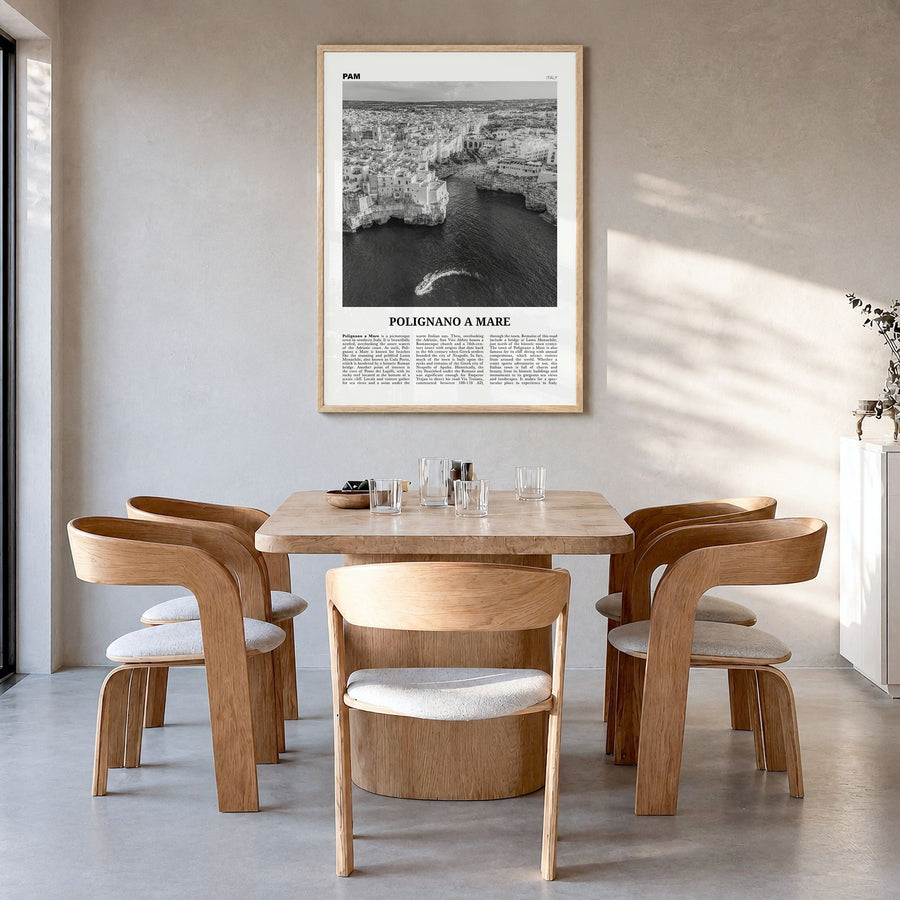 Polignano a Mare Newspaper Poster in a natural wood frame, hanging in a dining room