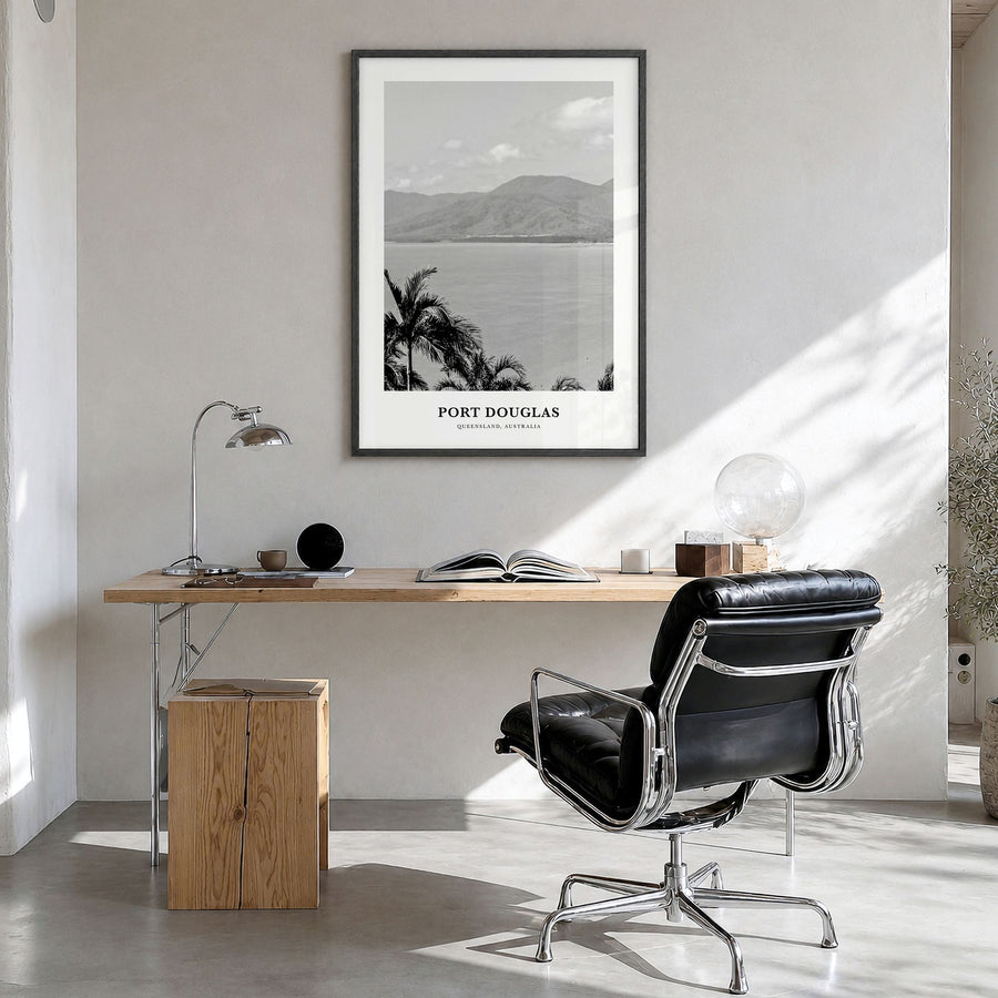 Port Douglas Classic Poster in a black wood frame, hanging in a bright home office